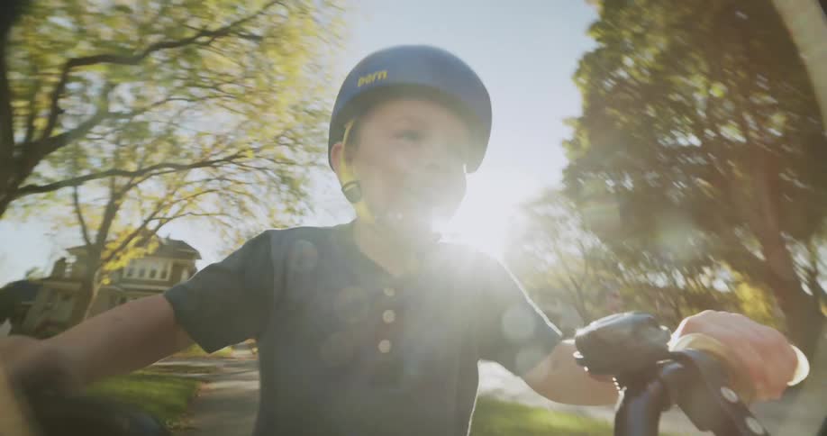 A child is riding his bike through town