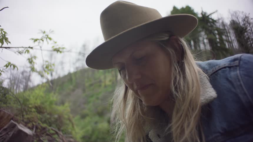 Portrait of a woman wearing a hat in an outdoor setting