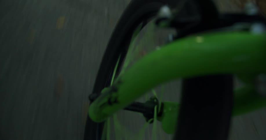 A green bike is riding around