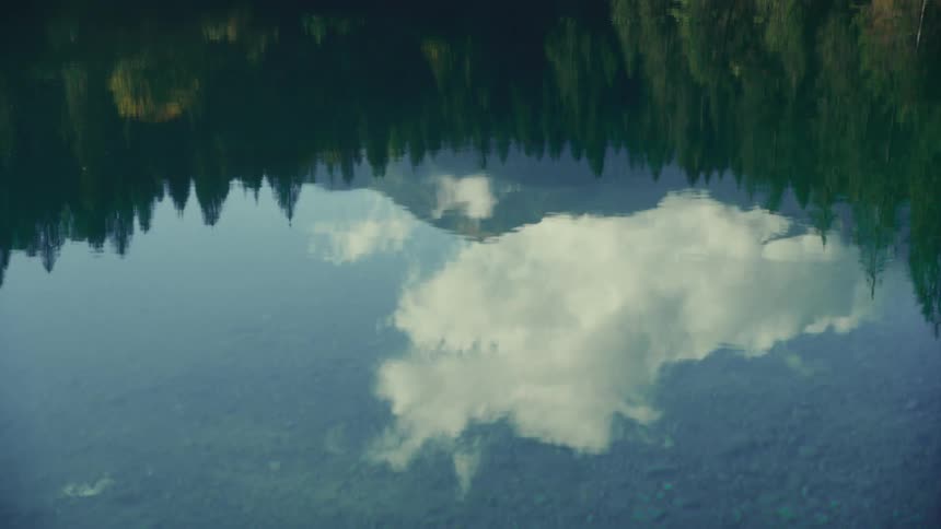 The sky is reflected in a pond