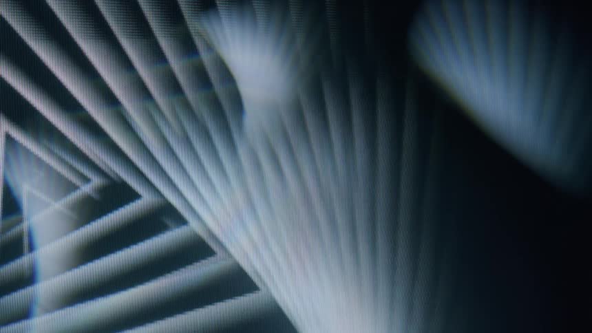 Abstract light patterns and digital artifacts create a dynamic visual effect on a screen