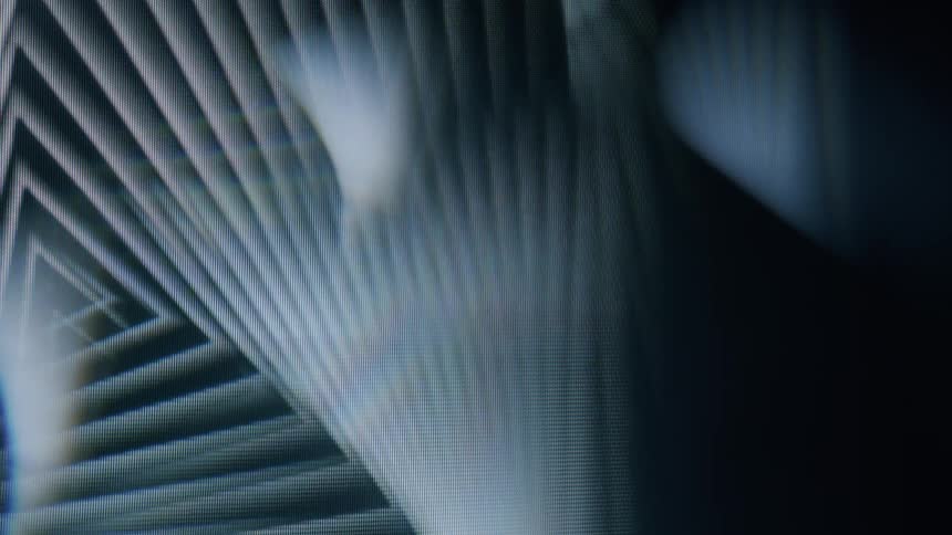 A psychedelic pattern of overlapping triangles and lines creating a sense of depth and distortion