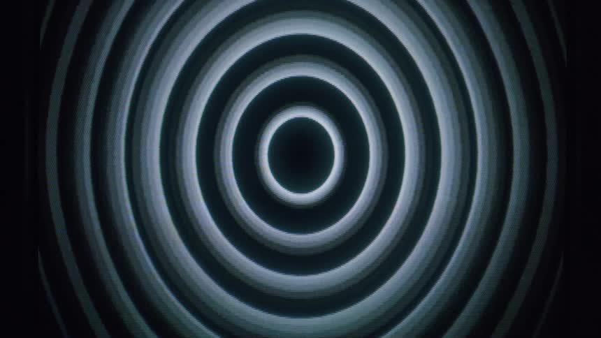 A series of concentric circles radiating outward from a dark center