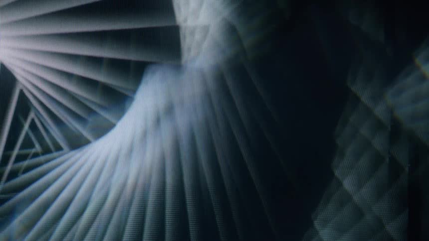 An abstract pattern of overlapping fanlike light beams creating a layered geometric effect in shades of gray and black