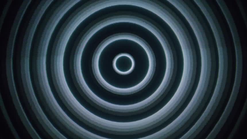 Abstract hypnotic circles emerging from a black background