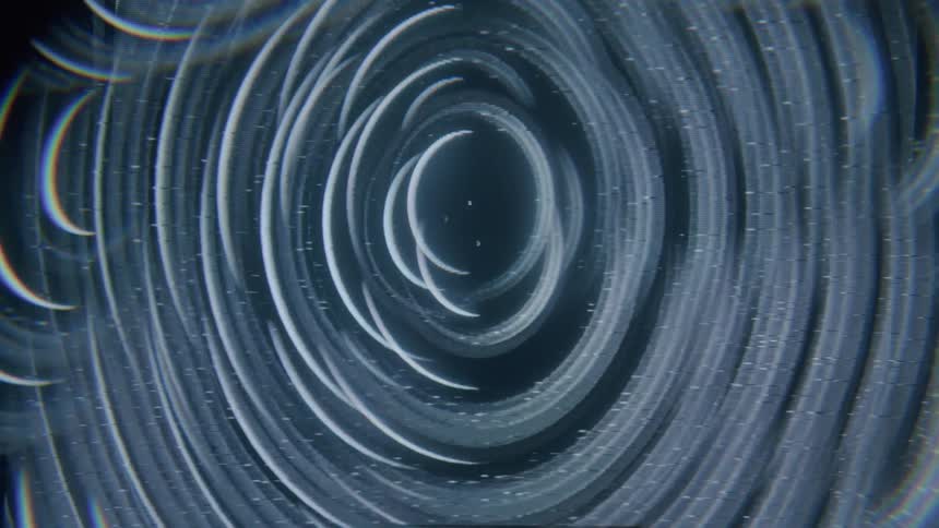 A swirling pattern of concentric circles with a dark center and a faint glow around the edges