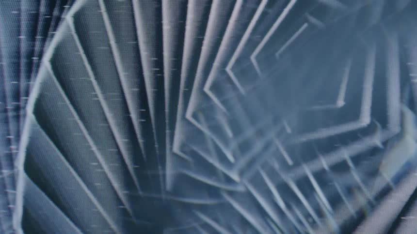 A spinning pattern of overlapping pentagons on an old crt screen