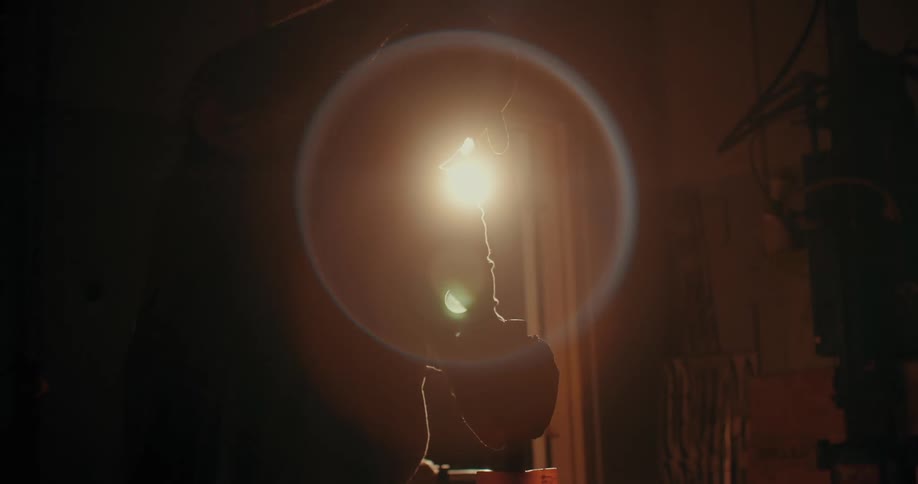 Silhouette of a man hammering a wooden handle