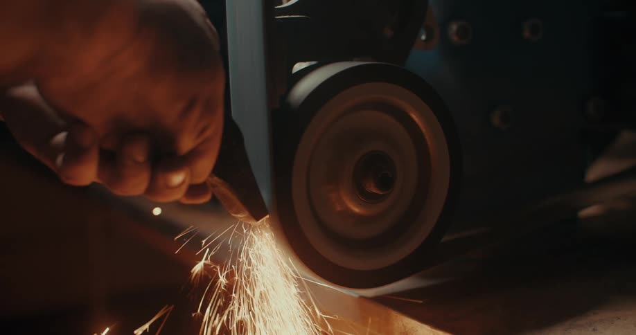 Carpenter shaping metal on a machine