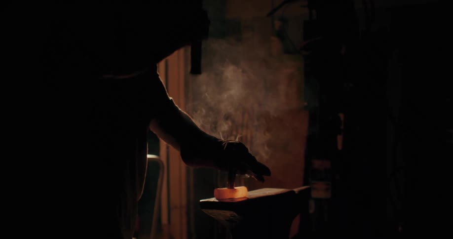 A blacksmith is hammering hot metal