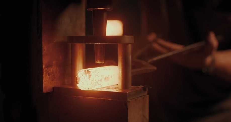 Person with a tool forging a metal