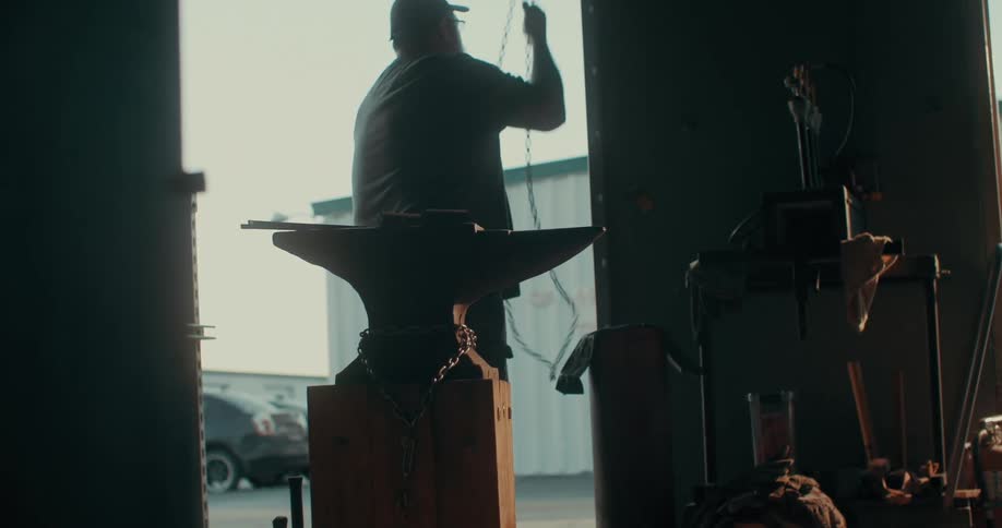 A blacksmith opens his workshop early in the morning