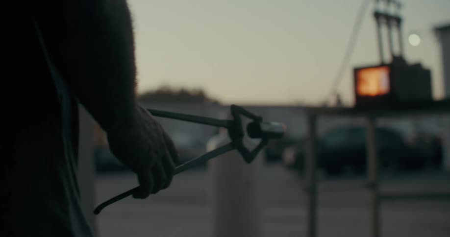 Silhouette of a papaya with a tool picking up a piece of metal and placing it inside a welding oven