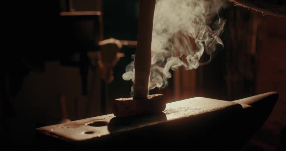 Wooden handle being placed on a hammer stand