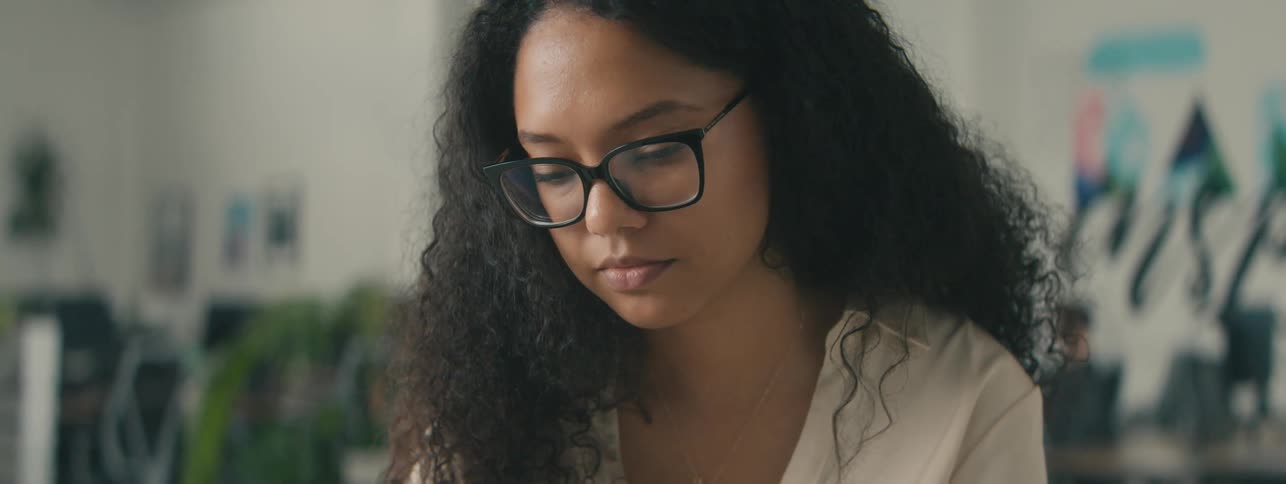 Portrait of a young woman wearing glasses in an office environment