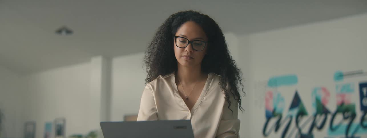 Woman working in front of an open laptop