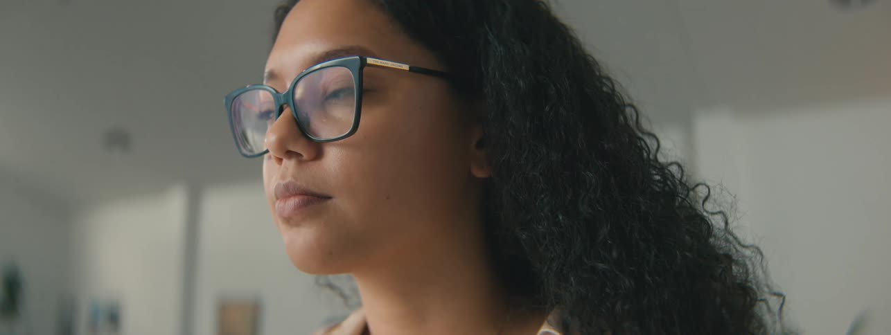 Close up of the face of a woman with curly working in the office