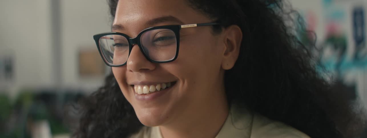 Portrait of a woman in an indoor space with a happy facial expression