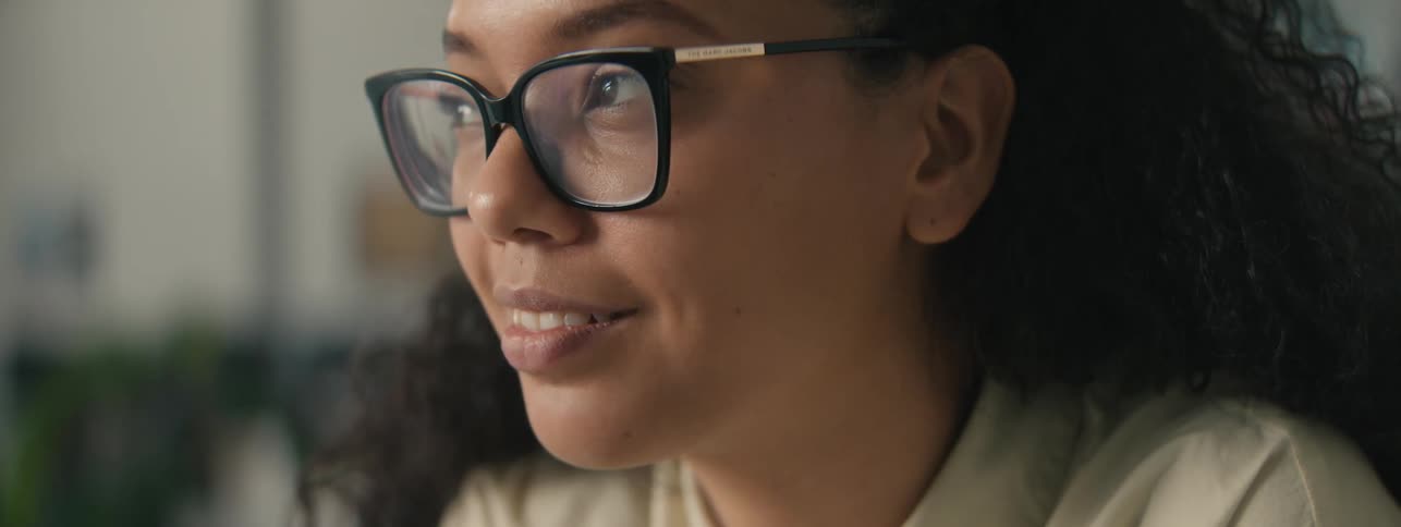 Portrait of a young woman wearing glasses smiling