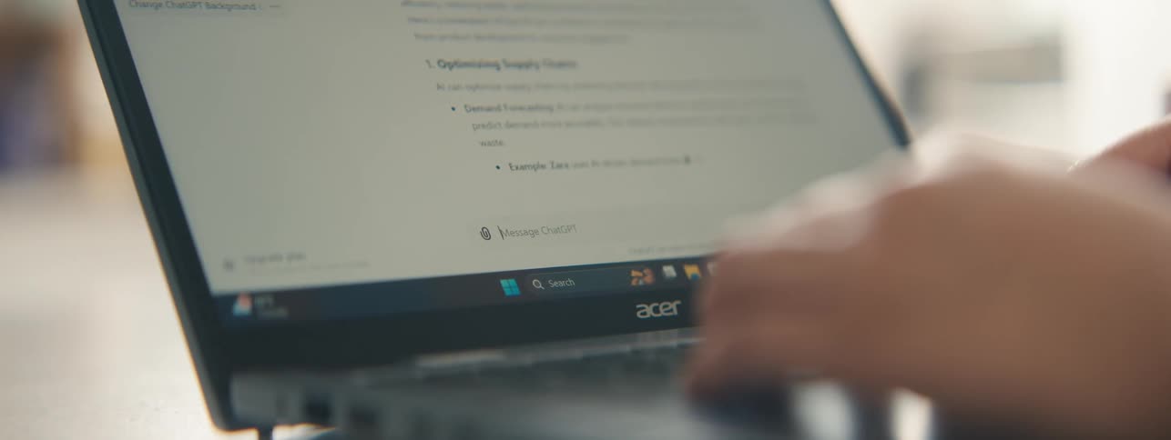 Hands typing text on a laptop