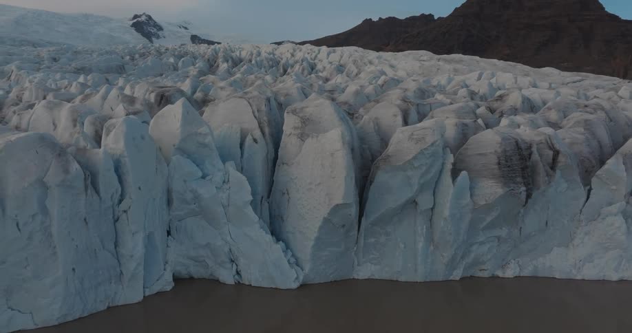 Large ice and snow formations fill a mountain valley