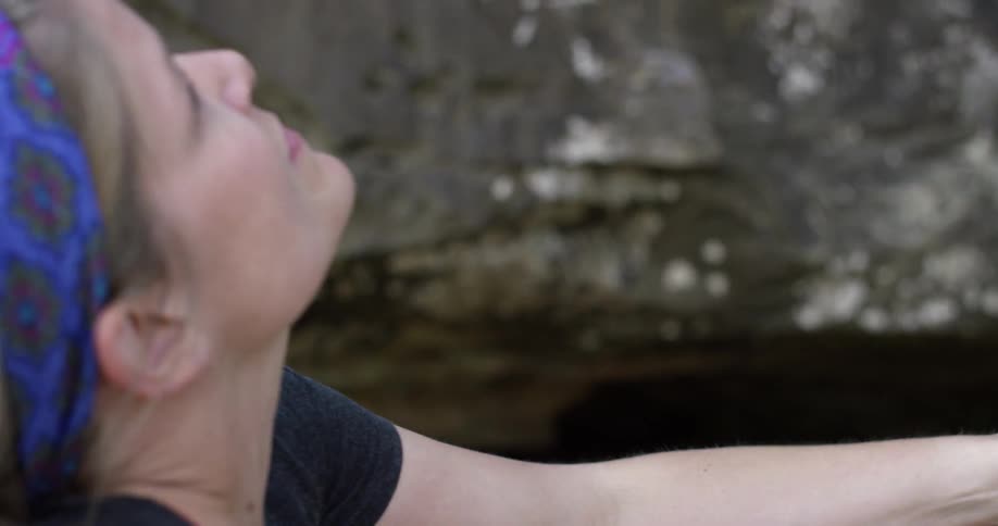 Woman rock climber studying what is above her