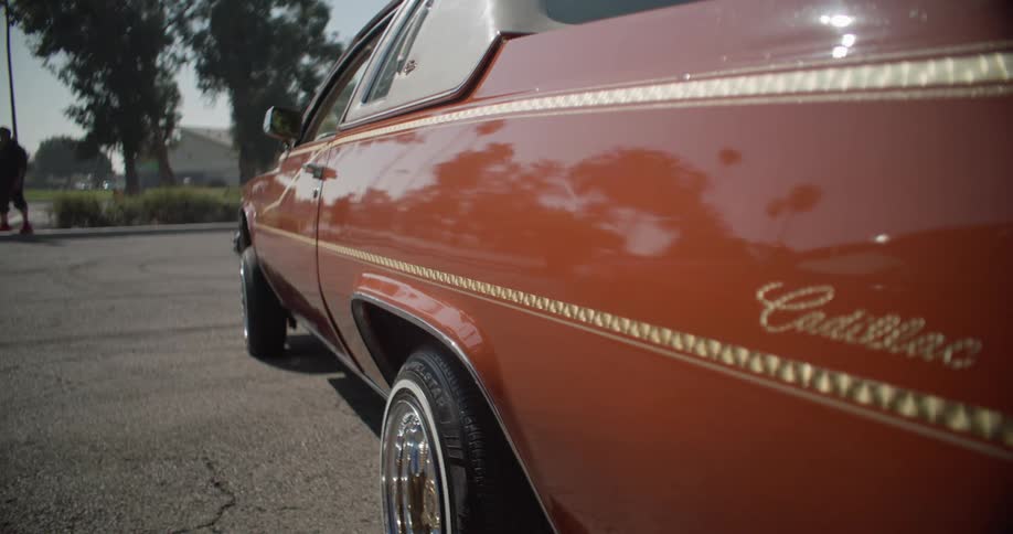 Side view of a parked classic red cadillac