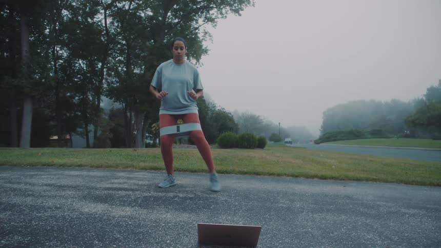 Woman using resistance band and doing educational strengthening exercises