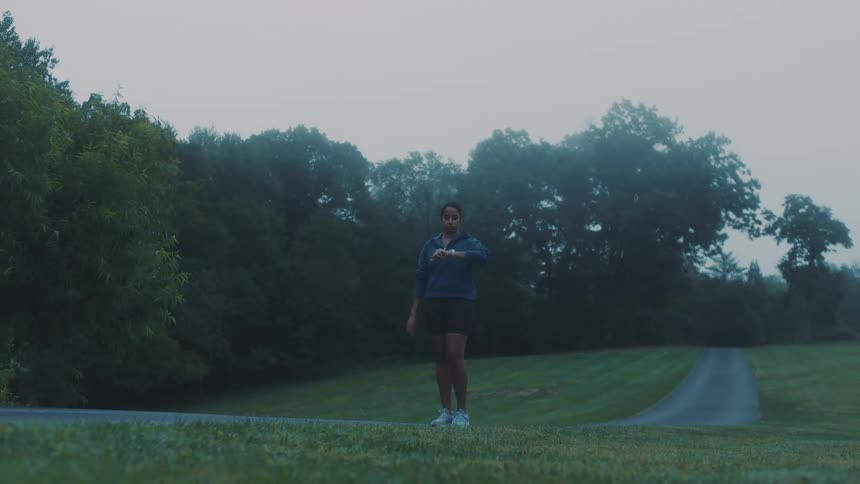 A woman jogs on a path in the park