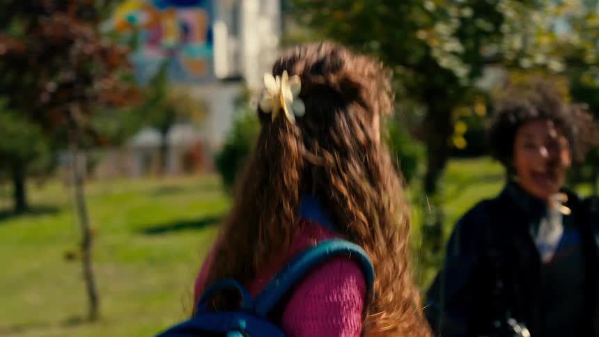 A group of happy friends walking together in a college campus