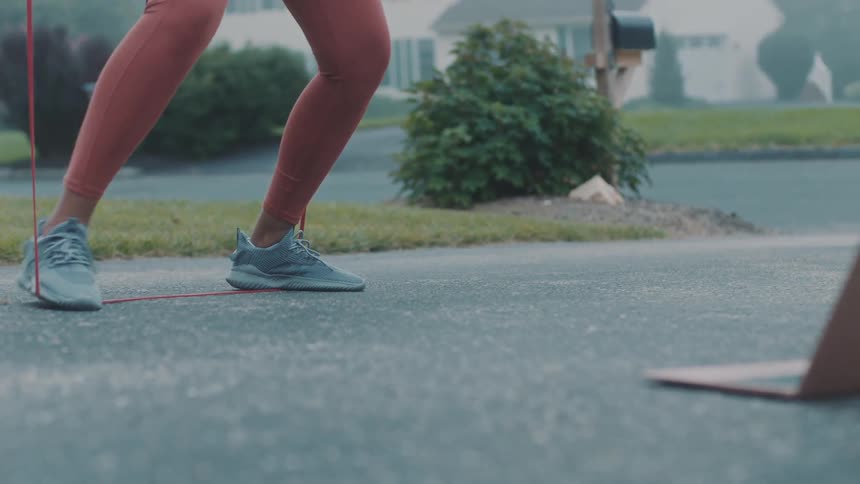 Legs of a woman using resistance bands and doing exercises