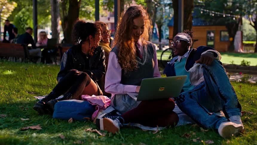 Friends talk and laugh in the park