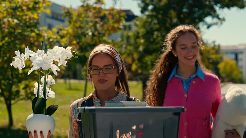 A group of friends arriving at a college campus with personal belongings