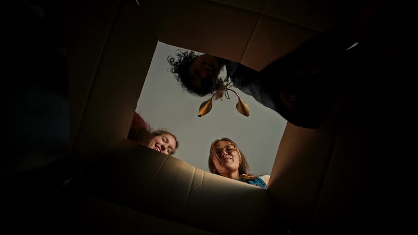 Women remove books from a box