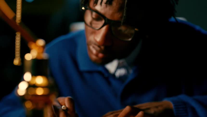 Young man writing and studying late at night