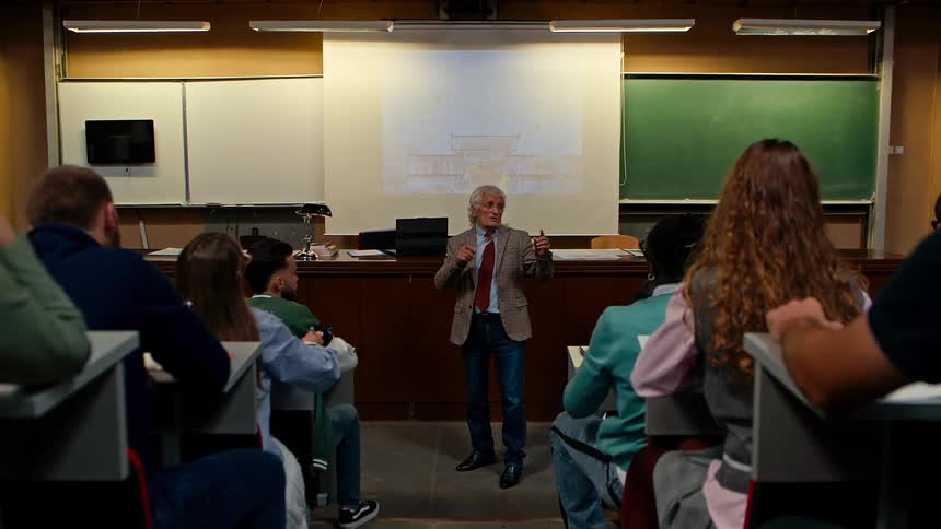Teacher in a classroom with students applying a subject