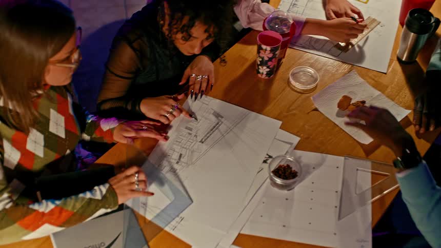 University students work together on group projects that involve drawing diagrams