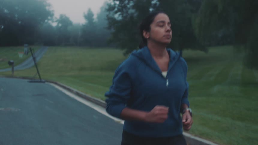 A woman is running on the trail