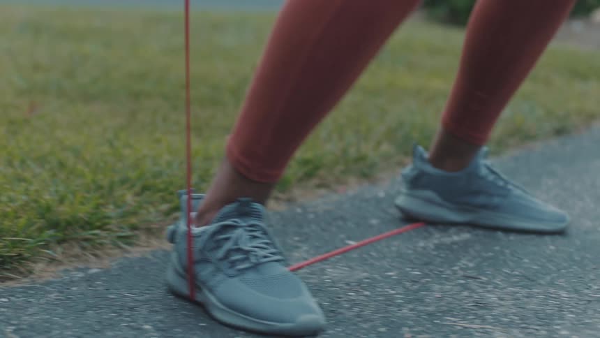 Legs of a woman using a resistance band