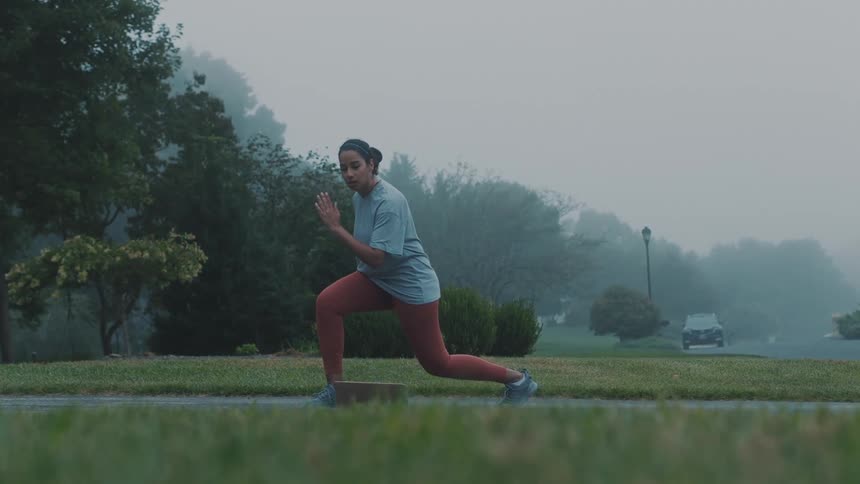 Woman doing educational running warmup exercise