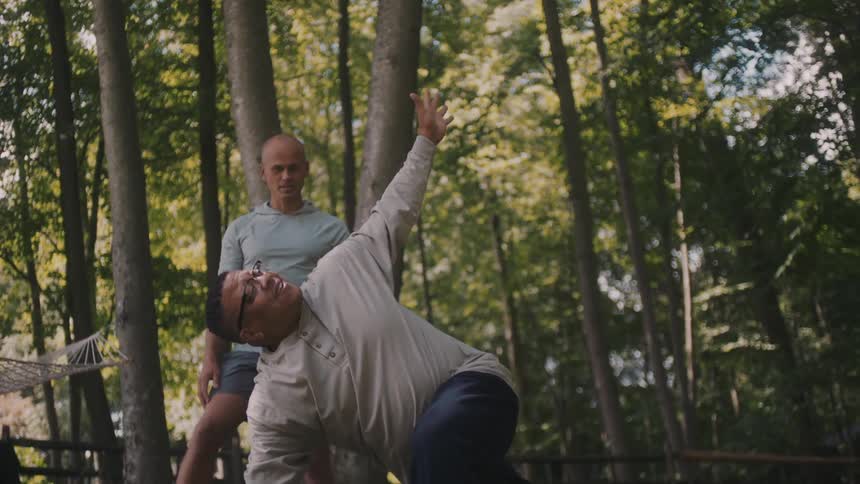 Men are doing yoga in the park