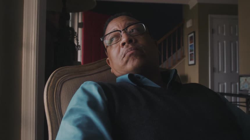 Thoughtful man sitting in an armchair in a room of the house
