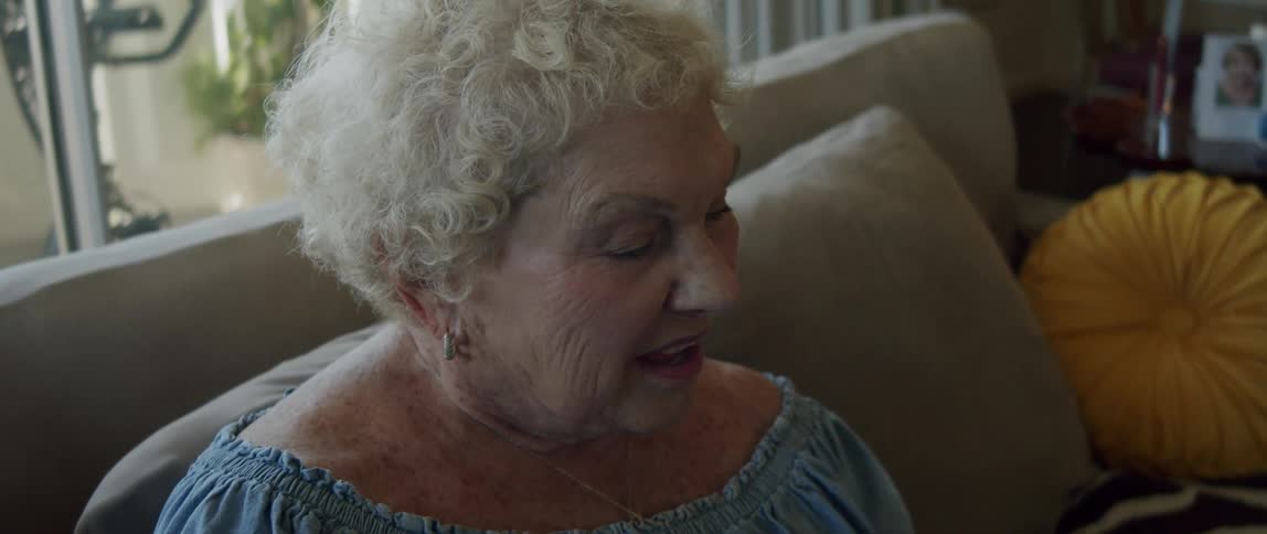 Portrait of an elderly woman sitting on the sofa in the living room