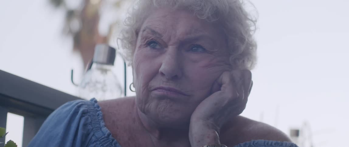 Portrait of an elderly woman reading the newspaper and looking thoughtful