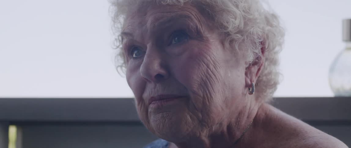 Elderly woman sitting on the porch