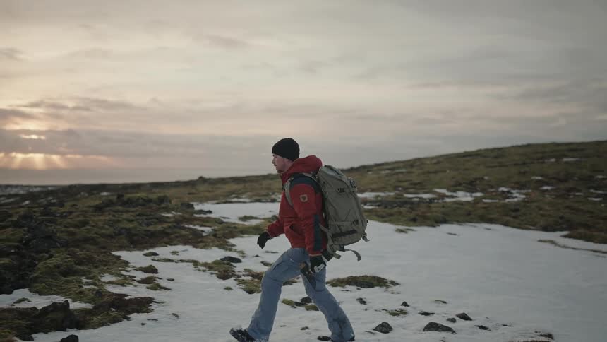 Man walking on a snowy mountain in the morning