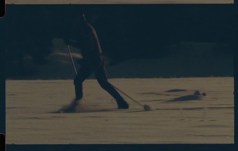 A person skiing on a winter landscape captured on vintage film
