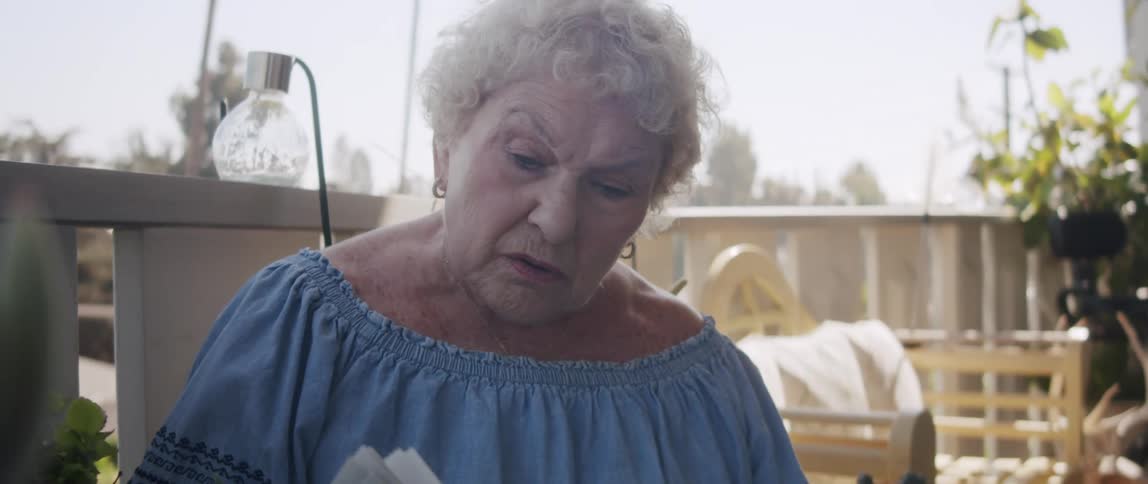 A clip of an elderly woman reading