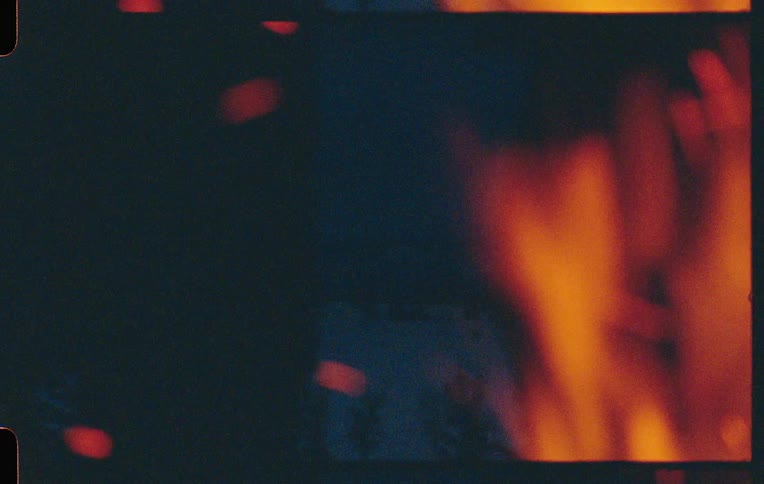 Fire flickers and dancing casting abstract shadows on the surrounding darkness