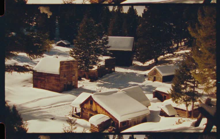Snowcovered village with several wooden structures